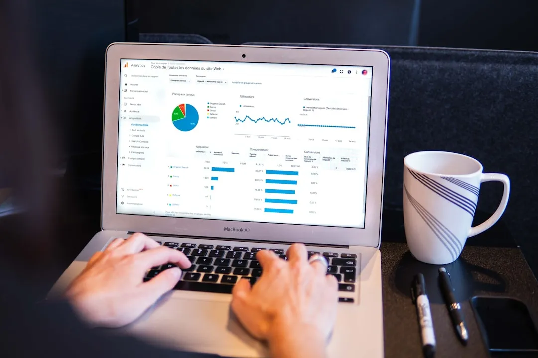 An engineer analyzing website analytics on a laptop dashboard
