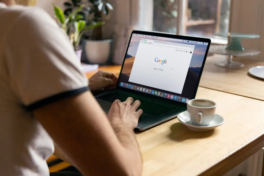 Someone opening Google search on a laptop at a desk