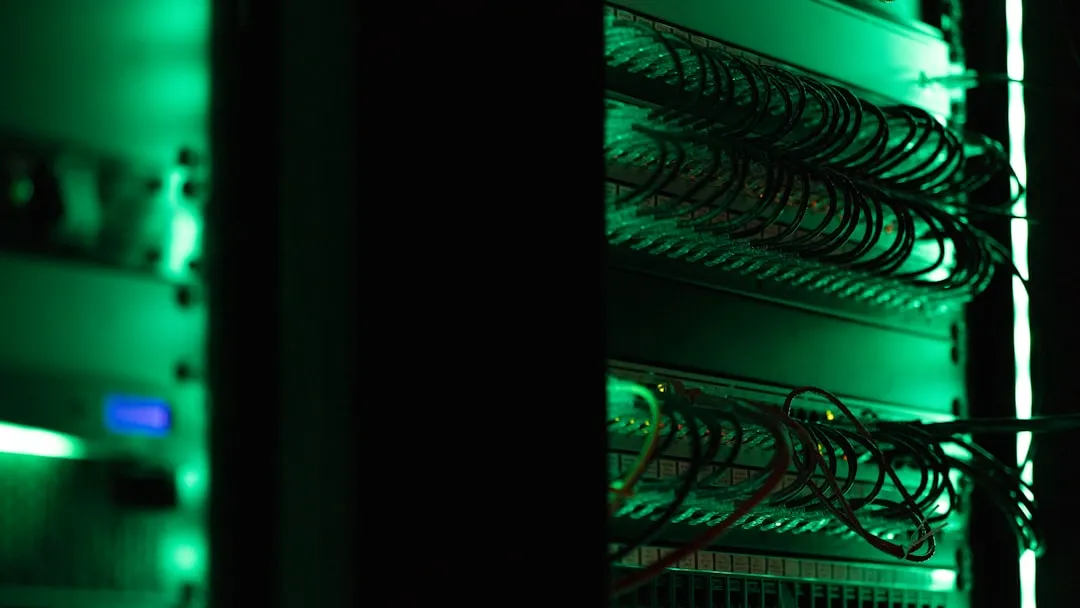 Server room racks with patch cabling under green indicator light