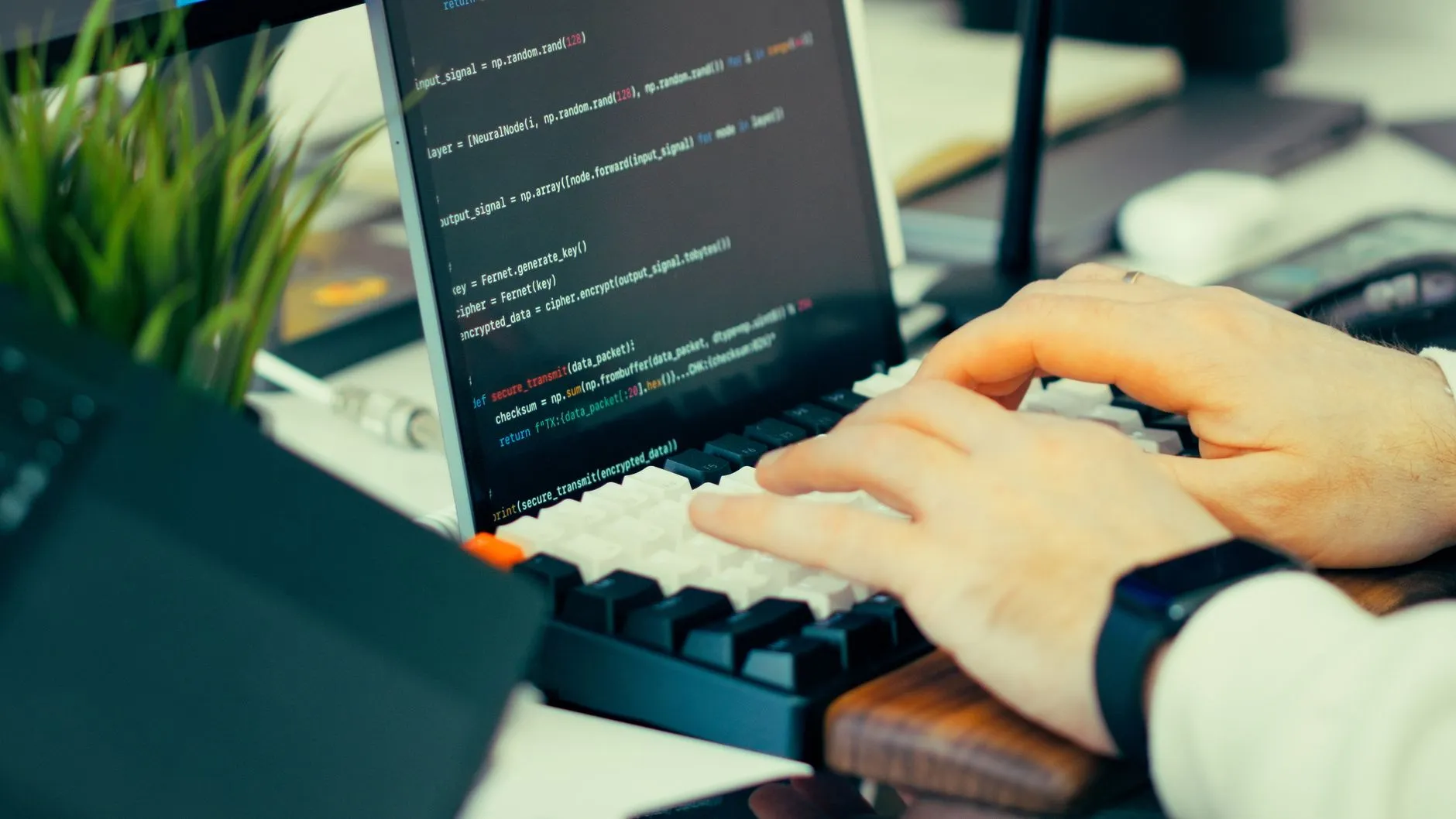 Software engineer writing framework code on a laptop terminal