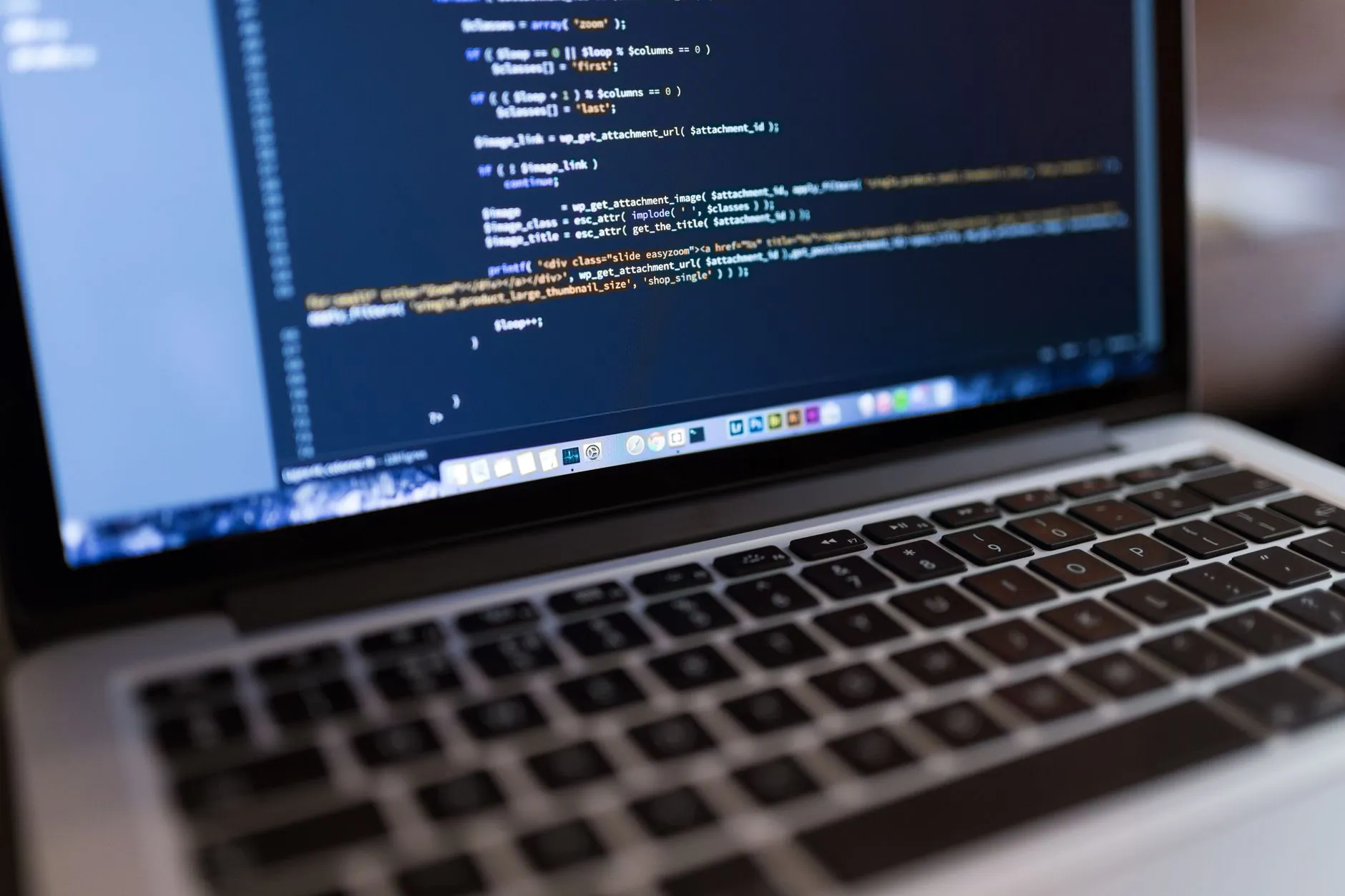Developer editing WordPress PHP code on a laptop